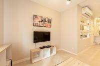 a living room with a flat screen tv on a wall at Brand new 1BR in central MALTA-Hosted by Sweetstay in Tal-Pietà