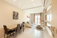 a dining room and living room with a table and chairs at Brand new 1BR in central MALTA-Hosted by Sweetstay in Tal-Pietà