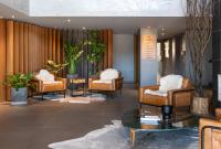 a lobby with a group of chairs and a table at Jangal das Araucárias Swan Design Hotel Canela in Canela