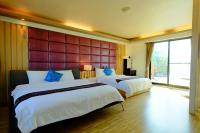 a hotel room with two beds and a large window at Yudo B&amp;B Yilan in Dongshan