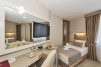 A bed or beds in a room at Marcello Hotel
