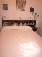 A bed or beds in a room at Hostal Esmeralda