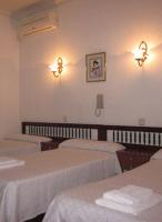 A bed or beds in a room at Hostal Esmeralda
