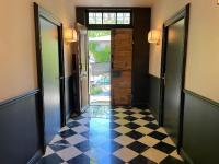 a hallway with a checkered floor and an open door at Villa Amara in Aix-en-Provence