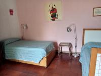 A bed or beds in a room at Il Giardino dei Merli