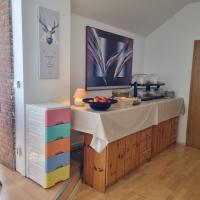 a kitchen with a counter with a bowl of fruit on it at Müritz-Pension Waren in Waren