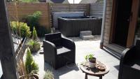 a patio with two chairs and a hot tub at B&amp;B Aquavert &amp; Wellness in Tournai