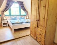 a bedroom with a bed and a window at Pension Landhaus Teichgraf in Wolgast