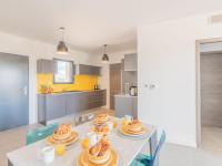 a kitchen with a table with plates of food on it at Apartment Stanatura-4 by Interhome in Porto-Vecchio