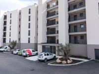 a parking lot in front of a building at Apartment Stanatura-4 by Interhome in Porto-Vecchio