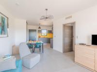 a living room with a dining room table and a kitchen at Apartment Stanatura-4 by Interhome in Porto-Vecchio