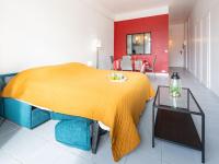 a bed with a yellow blanket in a room at Studio La Pergola-8 by Interhome in Saint-Jean-de-Luz