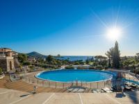 a swimming pool with the ocean in the background at Apartment Village Cap Estérel - L&#39;Esquinade-23 by Interhome in Agay - Saint Raphael