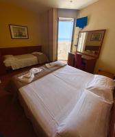 A bed or beds in a room at Hotel Audi Frontemare