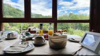 a table with food and a computer on top of it at Hotel Avelina in Cangas de Onís