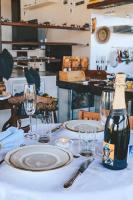 a bottle of wine sitting on a table with glasses at Pariká Pousada in Alto Paraíso de Goiás