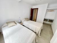 A bed or beds in a room at Piso en el Puerto de Dénia con balcón