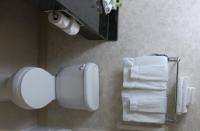 a bathroom with a toilet paper dispenser and towels at Holiday Inn Express Hotel & Suites San Dimas by IHG in San Dimas