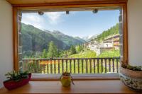 a window with a view of a mountain view at Hotel & Restaurant Perret - Mountain People in Valgrisenche