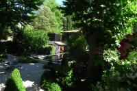 a view of a garden with a building and trees at Villa Amara in Aix-en-Provence