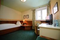 A bed or beds in a room at Gasthof Hotel Zweimüller