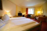 A bed or beds in a room at Gasthof Hotel Zweimüller