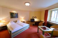 A bed or beds in a room at Gasthof Hotel Zweimüller