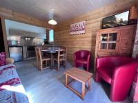 a living room with a table and chairs and a kitchen at Crepuscule 4 - Appartement proche pistes de ski et village in La Clusaz