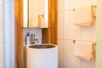 a bathroom with a sink and towels at Haus Bergblick in Fuschl am See