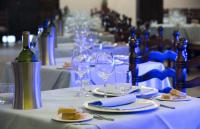 a table with wine bottles and plates of food and wine glasses at Hotel Cala di Mola in Porto Azzurro