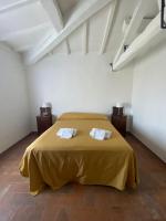 A bed or beds in a room at Agriturismo Diffuso Monte Oliveto Maggiore