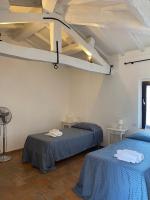 A bed or beds in a room at Agriturismo Diffuso Monte Oliveto Maggiore