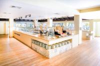 a large room with a counter with bowls on display at Coral Costa Caribe Beach Resort - All Inclusive in Juan Dolio