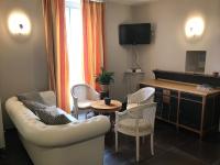 a living room with a couch and chairs and a table at Les Pastels in La Roche-sur-Yon