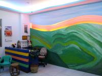 a room with a rainbow mural on the wall at Country Kos Hostel in Kenting