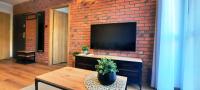 Televízia a/alebo spoločenská miestnosť v ubytovaní Asti Apartamenty Centrum Stargard