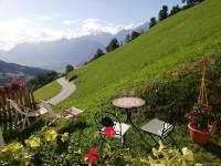 a table and chairs sitting on a hill with a road at Much`s Bergstüberl in Wattenberg