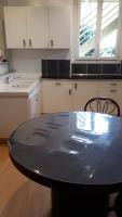 a kitchen with a black table and chairs in it at Pavillon Kalensa in Vals-les-Bains