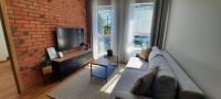 Televízia a/alebo spoločenská miestnosť v ubytovaní Asti Apartamenty Centrum Stargard