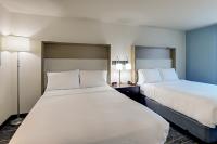 a hotel room with two beds and two lamps at Holiday Inn Mobile Airport by IHG in Mobile