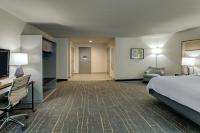 a hotel room with a bed and a flat screen tv at Holiday Inn Mobile Airport by IHG in Mobile