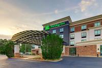 a hotel with a sign on top of a building at Holiday Inn Mobile Airport by IHG in Mobile