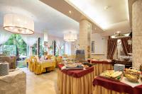 a restaurant with tables with food on them at Milton Boutique Hotel - Adults Only in Lido di Jesolo