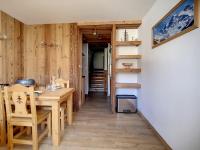 a dining room with a wooden table and chairs at Appartement Les Menuires, 2 pièces, 5 personnes - FR-1-344-855 in Les Menuires