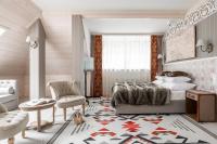 a bedroom with a bed and a living room at Aries Hotel & SPA Wisła in Wisła