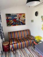 a living room with a couch and a painting on the wall at Maison Lolly corse wifii free in Borgo