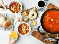 a table with bowls of food and a pot of soup at The Millennials Kyoto in Kyoto