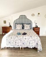 a bedroom with a bed with a blue and white bedspread at LE VIEUX MOULIN in Bouhet