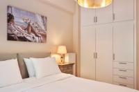 A bed or beds in a room at Spirou Merkouri Handcrafted 2BD Home
