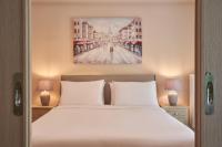 A bed or beds in a room at Spirou Merkouri Handcrafted 2BD Home